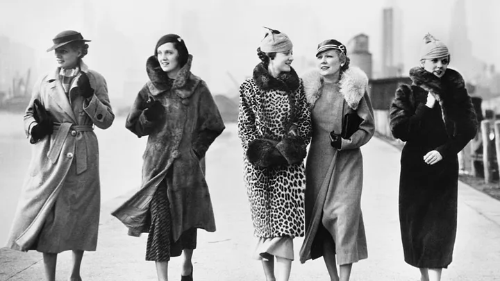 A black and white photo of a group of women in winter coats