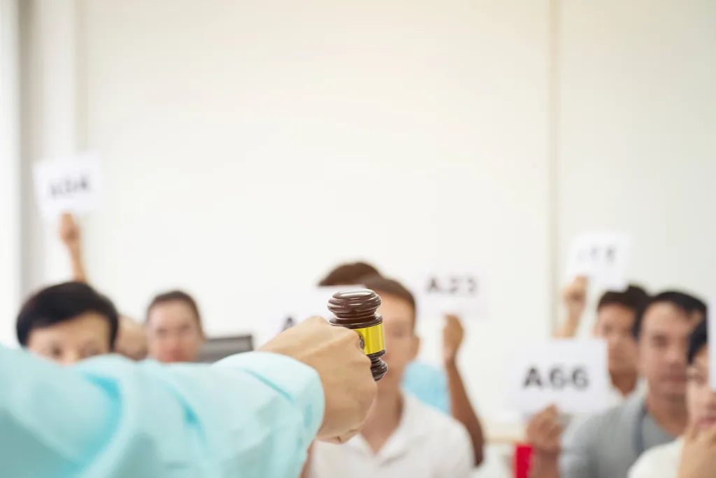 An auctioneer holding a gavel at an auction