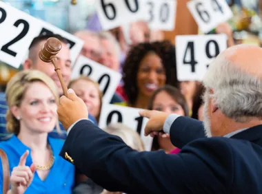 An auctioneer pointing at someone in the crowd