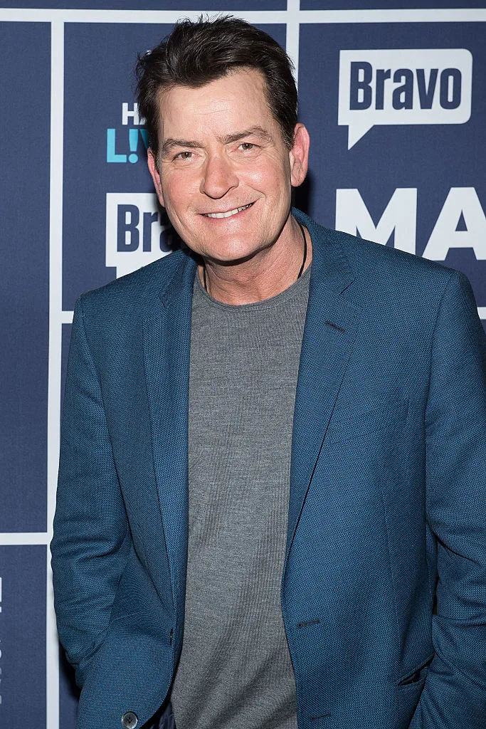 A portrait of Charlie Sheen in a blue blazer