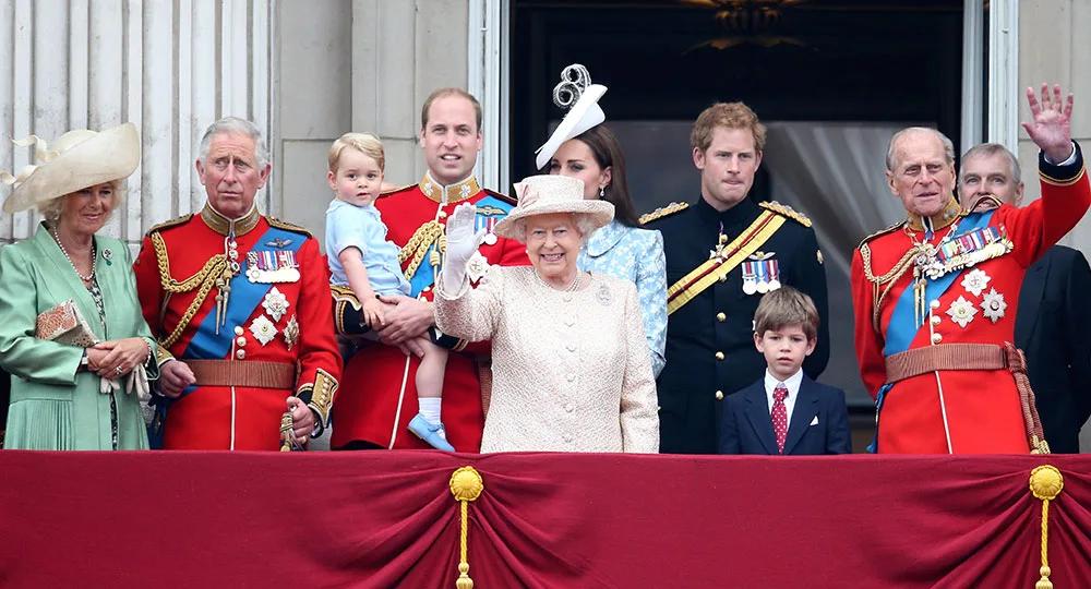 Royal family on Buckingham Palace balcony, Trooping the Colour ceremony, with Queen waving, surrounded by family members.