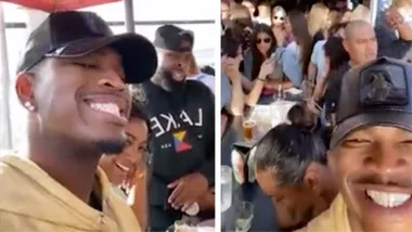 Ne-Yo in good spirits hangs out with friends at rooftop bar