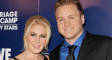 Couple posing at a "Marriage Boot Camp" event, smiling in formal attire.