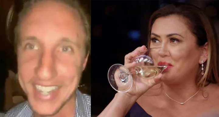 Two people smiling; one man in a plaid shirt, one woman drinking wine while wearing earrings.