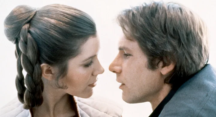 Two characters from Star Wars, one with braided updo, face each other closely in an intimate moment.