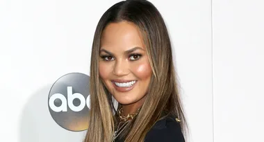 Person smiling at an event with an ABC logo in the background.