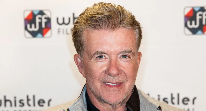 A smiling man with gray hair at a Whistler Film Festival event backdrop.