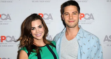 Two people smiling at an ASPCA event backdrop.