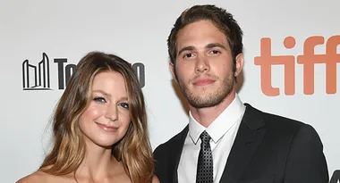 Two people smiling at the Toronto International Film Festival (TIFF) event backdrop.