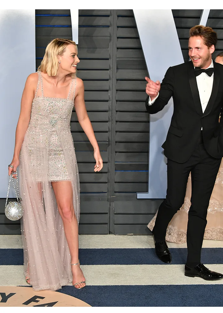 margot robbie and tom ackerley on the red carpet for the oscars in 2021