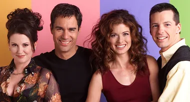 Four smiling people standing in front of a colorful background.