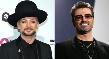 Two men in black outfits; the left one wears a wide-brimmed hat, the right one with sunglasses and a beard.