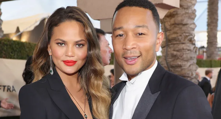 I'm sorry, I don't know who these people are. A woman and man dressed formally, smiling at an outdoor event.