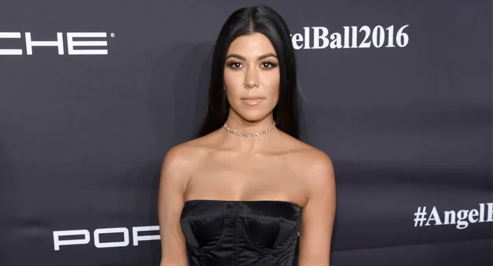 Woman in black strapless dress attends the Angel Ball 2016.