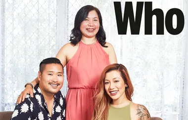 Three people in a posed photograph, with one standing and two seated, against a light background with "Who" text above.