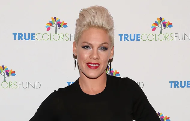 Singer with short blonde hair, wearing black, smiling at the True Colors Fund event.