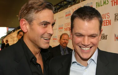 Two men in suits smiling on the red carpet for "Ocean's Thirteen" premiere.
