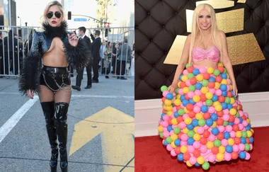 "Two people in eye-catching outfits; one in black leather and chains, the other in a colorful ball gown."