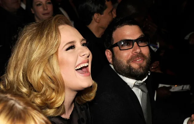 Individuals laughing and enjoying a moment at an event.