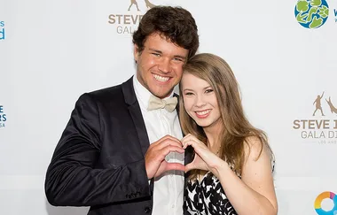 Two people smiling and forming a heart shape with their hands at the Steve Irwin Gala Dinner event.