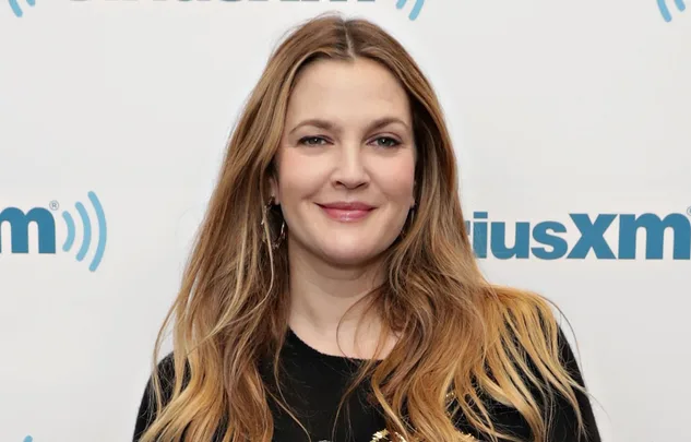 A person smiling in front of a SiriusXM backdrop.