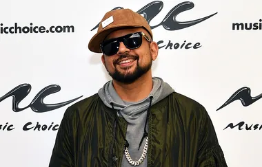 Man in sunglasses and cap smiling at a Music Choice event.