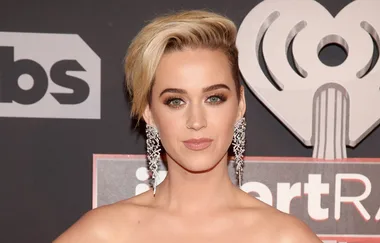 I don't know who this is, but the person has short blond hair and is wearing large silver earrings at an event.