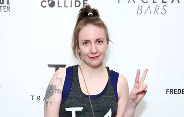 A person with a ponytail shows a peace sign, wearing a sleeveless top. Background has logos, including "Collide" and "Bars".
