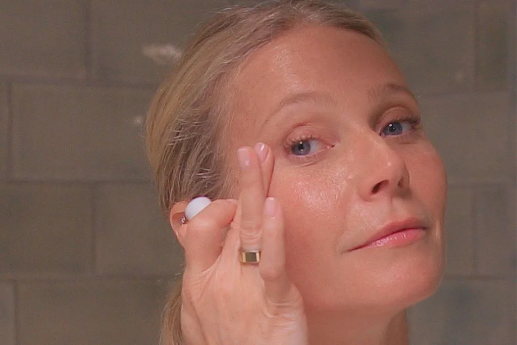 Gwyneth-paltrow-close-up-of-her-face-applying-skincare-produce