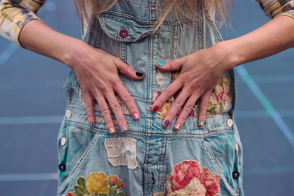 Taylor-Swift's-hands-displaying-her-nails-each-painted-to-represent-one-of-her-albums
