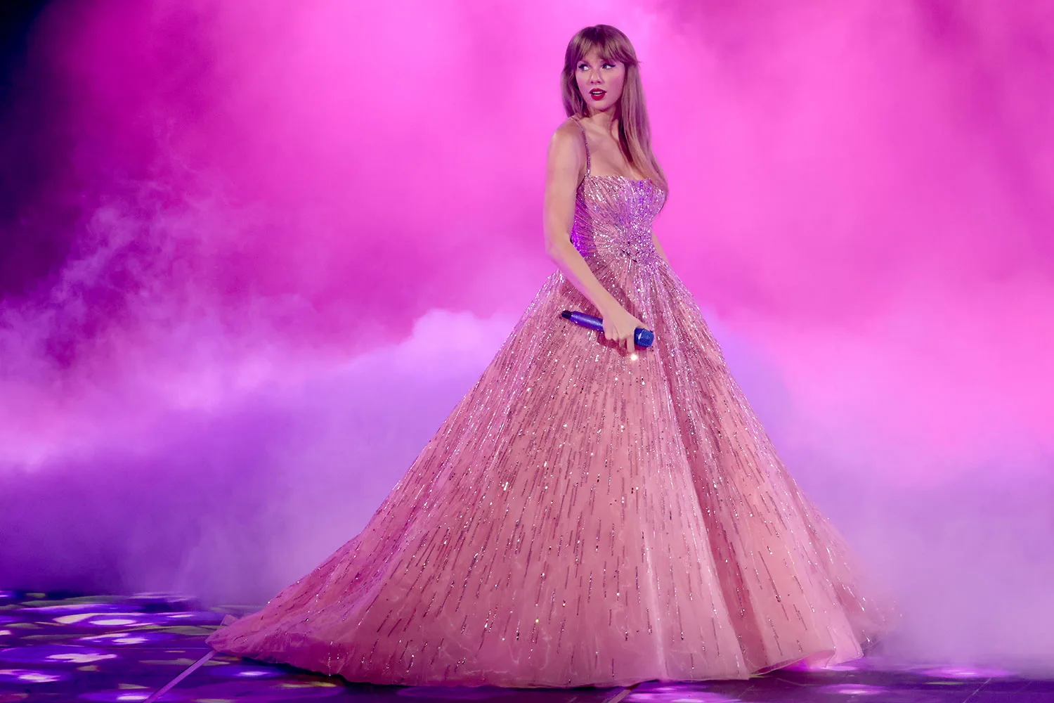 Taylor-swift-performing-on-stage-in-a-pink-sparkly-ball-gown