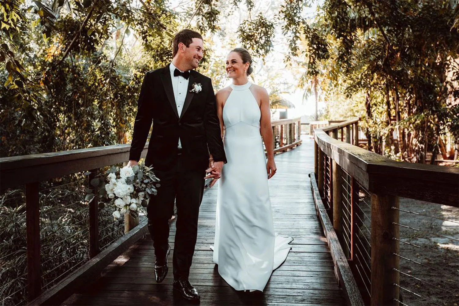 Ash-barty-and-gary-kissick-holding-hands-and-walking-in-wedding-attire