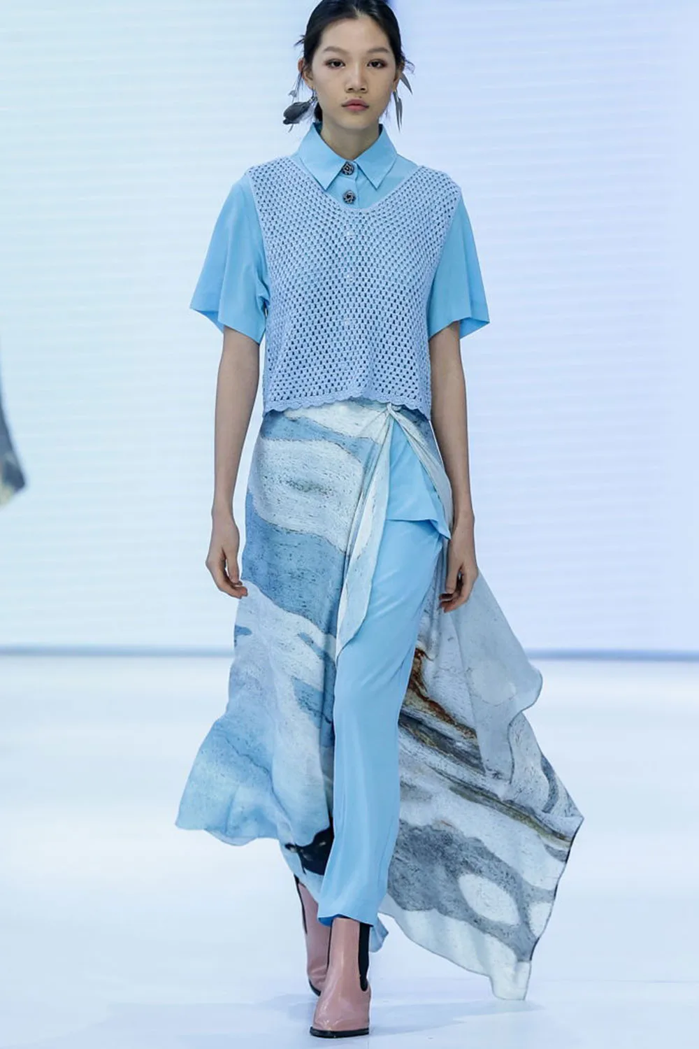 model-on-catwalk-wearing-blue-flowing-design-by-ngali