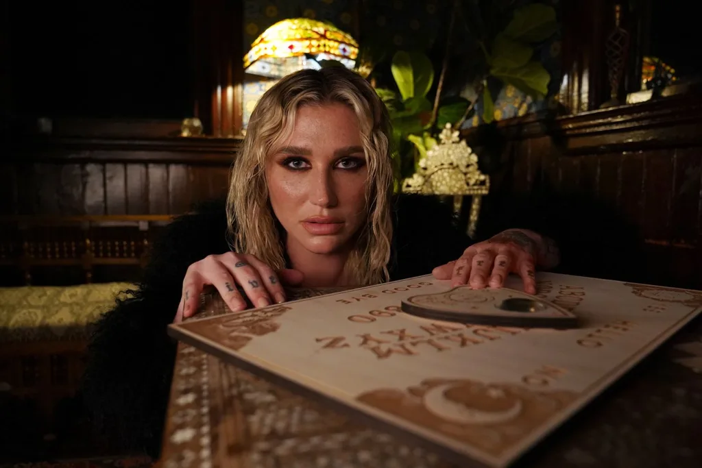 kesha-looking-down-camera-while-using-a-ouija-board