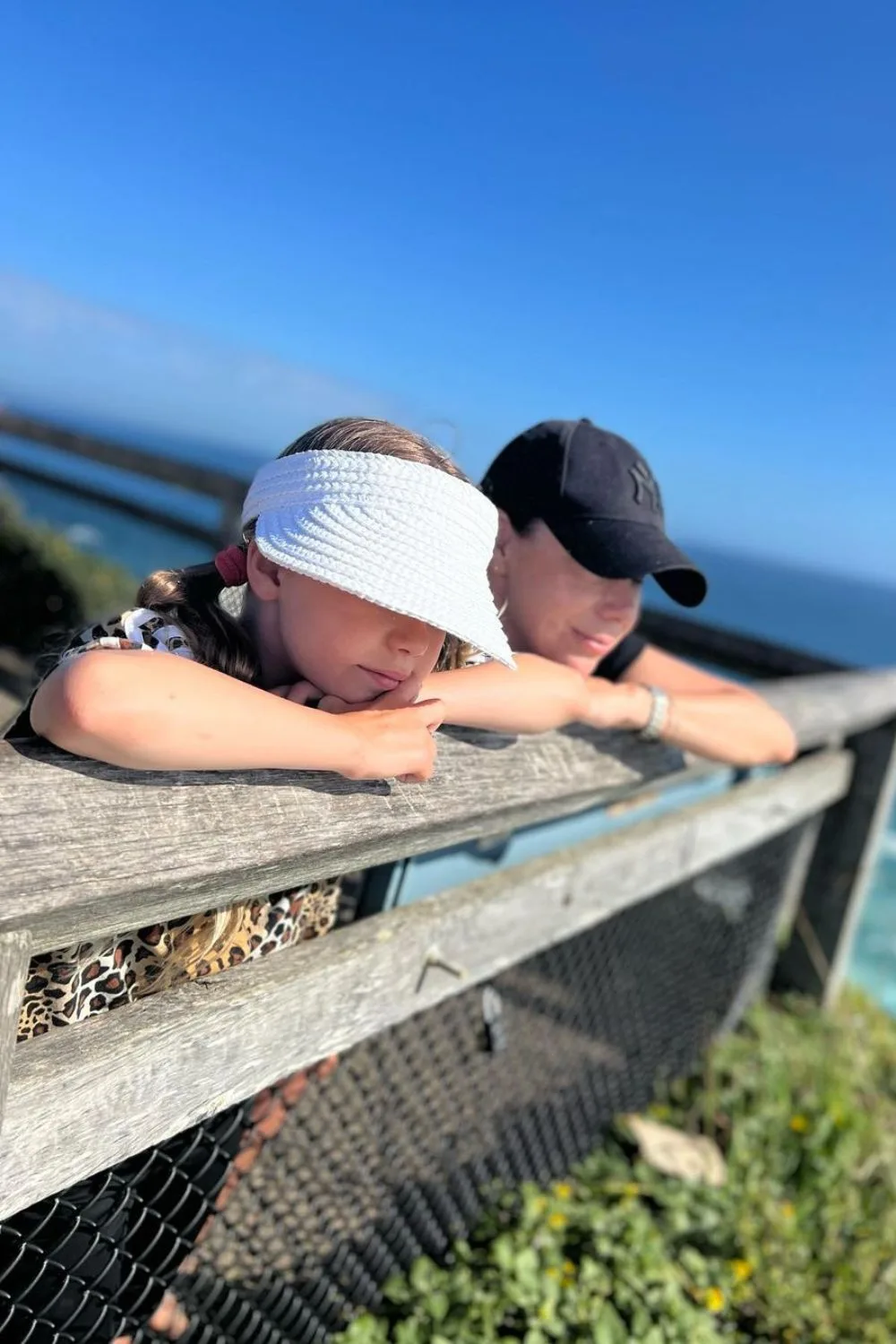 kate-ritchie-and-daughter-at-coastal-lookout-in-baseball-caps