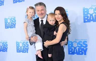 Family poses at "The Boss Baby" premiere, standing together, smiling, with promotional background visible.