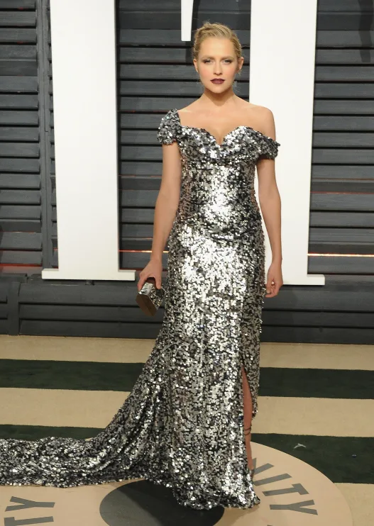 Silver dress with sequins, off-the-shoulder design, and train, worn by a person at a formal event.