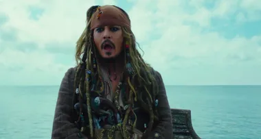 Pirate with long dreadlocks, wearing a bandana, surprised expression, seated on a ship against a calm ocean backdrop.