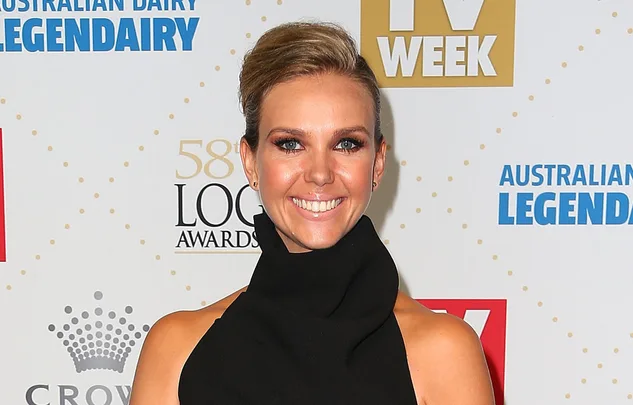 Celebrity in black dress smiles at 58th Logie Awards event backdrop.