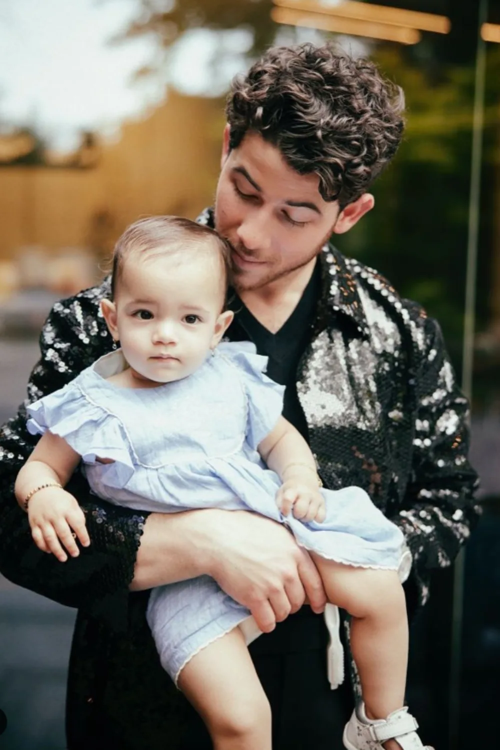Nick Jonas holding his daughter, Malti Marie