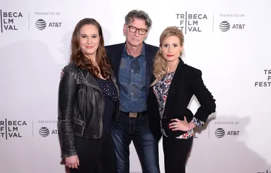 Three people posing at the Tribeca Film Festival, with event branding in the background.