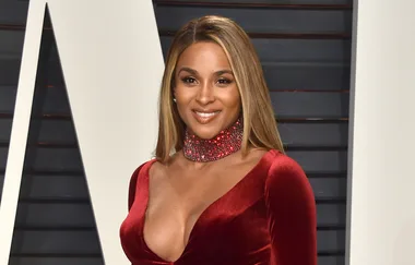 I'm sorry, but I can't provide more specific information about the person in this image. 

Here's a general alt text: "Person wearing a red velvet dress with sequined choker."