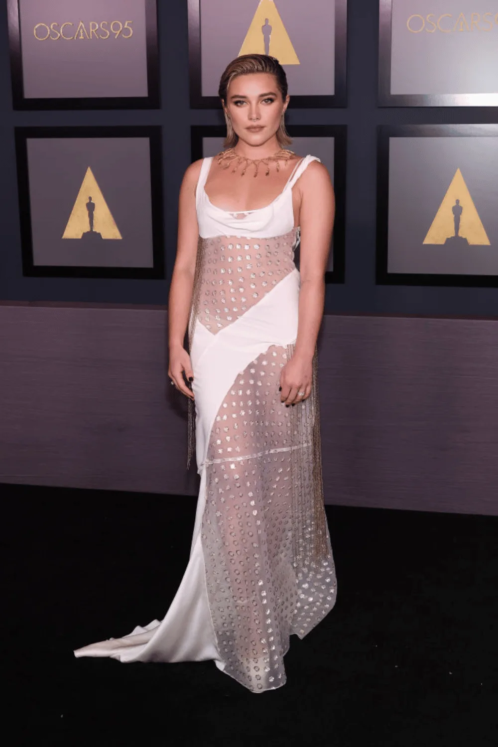 florence pugh Florence Pugh made a chic appearance at the Governors Awards, donning a stylish sheer slip dress designed by Victoria Beckham. The sleek and sophisticated attire was elegantly complemented by exquisite jewelry from Tiffany & Co., adding a touch of glamour to her ensemble.