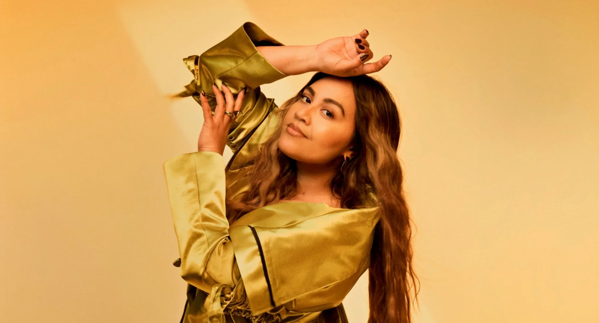 Jessica Mauboy in a gold outfit