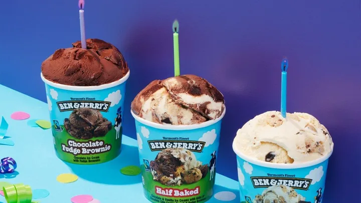 three tubs of ben and Jerry's with candles