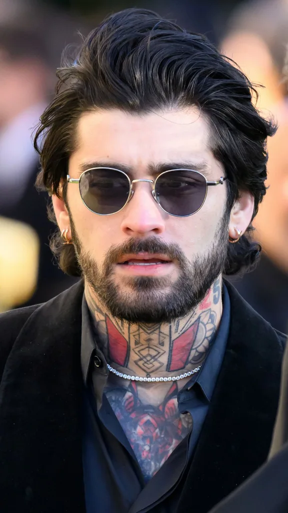 Former One Direction band member Zayn Malik leaves following the funeral for singer Liam Payne, former member of One Direction, on November 20, 2024 in Amersham, England. Former One Direction star Liam Payne's private funeral in Amersham has been widely anticipated to draw celebrities and fans alike, wishing to pay their final respects. The singer died after falling from a hotel balcony in Buenos Aires on October 16.