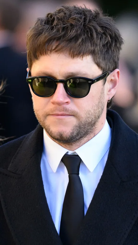 Niall Horan departs the funeral for singer Liam Payne, former member of One Direction, on November 20, 2024 in Amersham, England. Former One Direction star Liam Payne's private funeral in Amersham has been widely anticipated to draw celebrities and fans alike, wishing to pay their final respects. The singer died after falling from a hotel balcony in Buenos Aires on October 16.