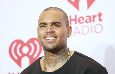 Chris Brown claims this photo of him choking a woman is just “playing”