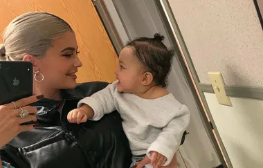 Kylie Jenner poses for a BOSS family portrait with Travis and Stormi