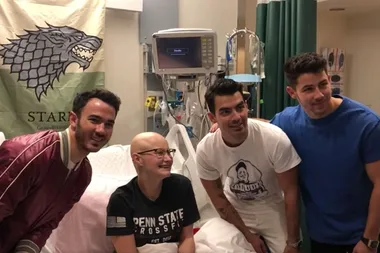 The Jonas Brothers make a surprise visit to a fan who missed their concert because of her chemotherapy